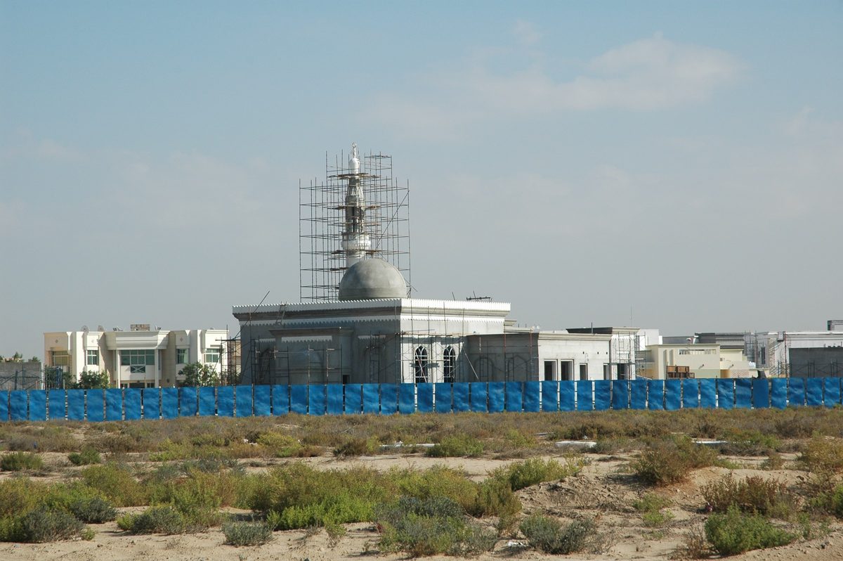 A mosque under scaffolding among low villas in Al Barsha 2, open scrubland in front, photographed in 2009