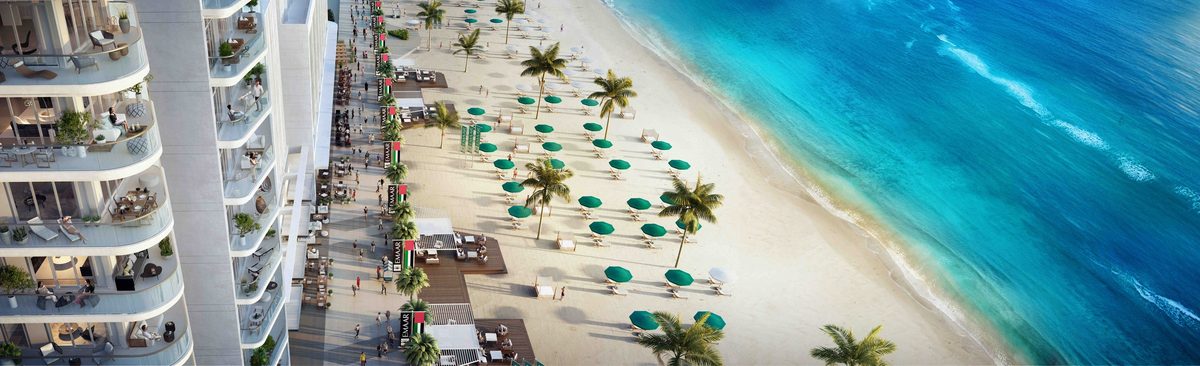 Emaar's render of the Emaar Beachfront promenade from above: a tower's balconies, the boardwalk with cafés, green parasols on the sand and the surf