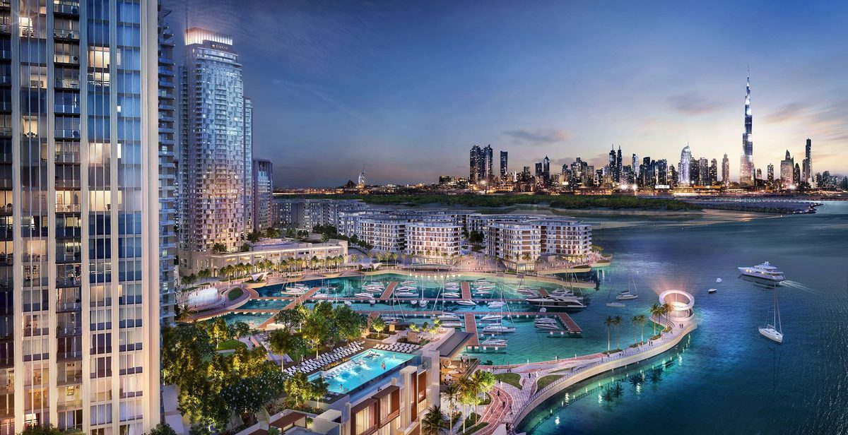 Emaar's render of Dubai Creek Harbour at dusk from the air: the Creek Island towers, the marina and the Downtown skyline across the creek