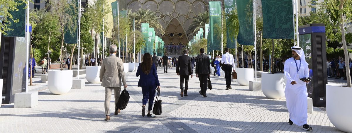 Delegates walking towards the Al Wasl Plaza dome at Expo City Dubai during COP28 in December 2023