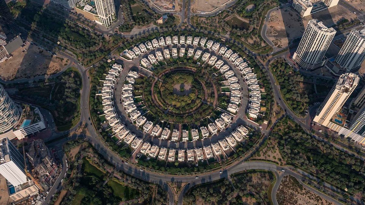 Straight down on Nakheel's circular villa cluster in Jumeirah Village Circle, the park at its centre and towers at the edges