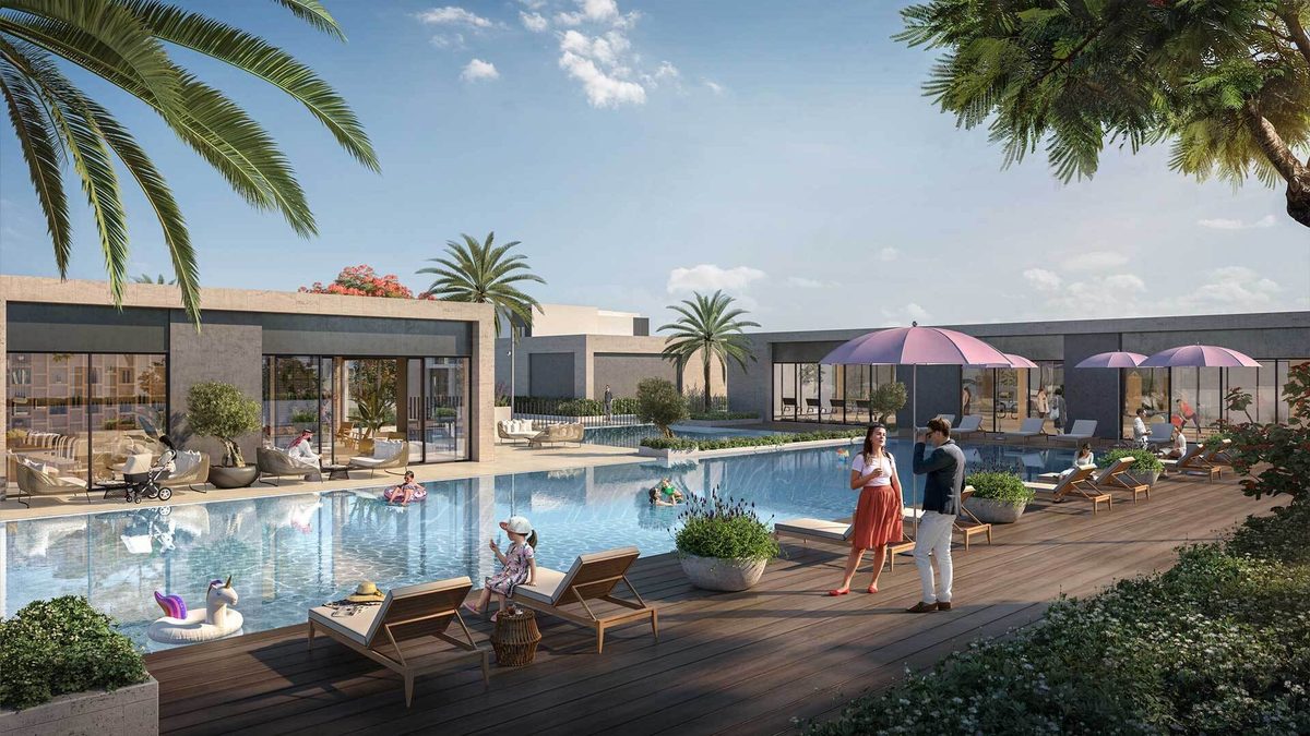 Emaar's render of a community pool at The Valley: a timber deck with loungers and pink parasols, a low pavilion behind