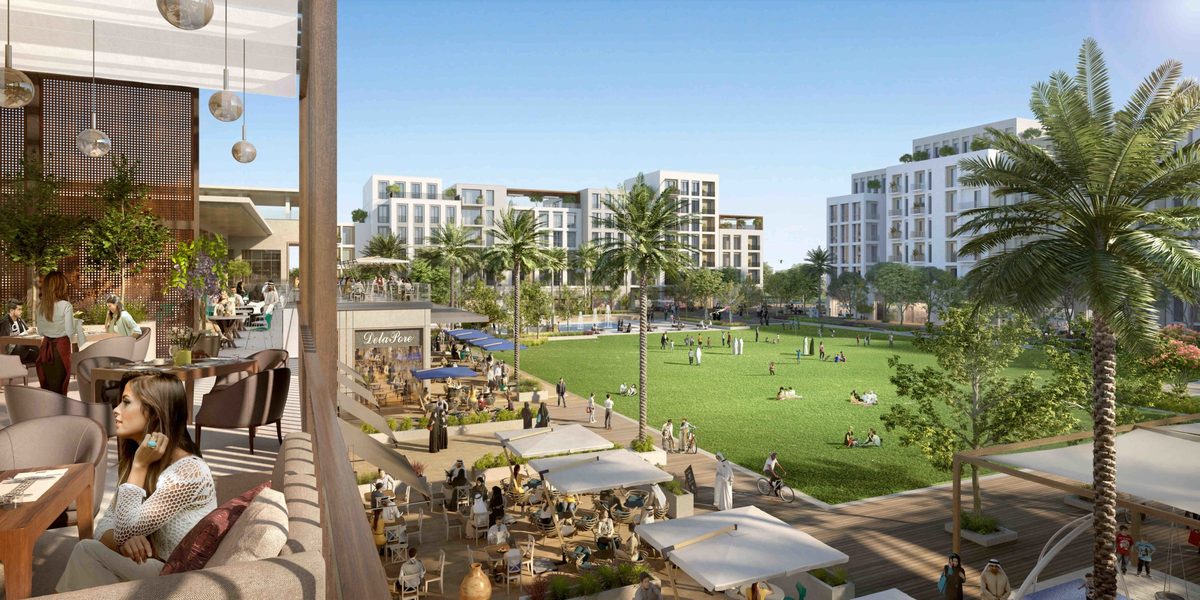 Emaar's render of The Valley's town centre: a café terrace looking over a lawn with palms, low apartment blocks around it